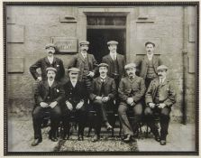 An interesting b/w photograph print of Tom Stewart seated with other golfers outside the St