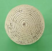 A large white concentric circle rubber core golf ball c1900 – retaining good shape, colour, no