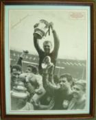 Bobby Moore signed print: 1964 FA Cup Final print Booby Moore lifts the FA Cup in triumph after West