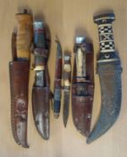 Collection of Vintage Knifes and Daggers: Carved wooden handled hunting knife carved with a moose