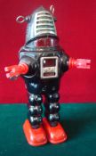 Tinplate clockwork Planet Robot: Black tinplate body and legs, red plastic hands and tinplate