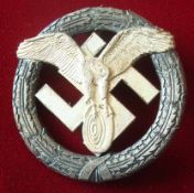 NSKK German Motor Sport Badge: Circular Laurel having Swastika with eagle holding a Wheel and Thin