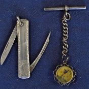 A silver plated folding double bladed pen knife with one panel embossed with a Victorian golfer,