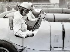 2x large motor racing b&w photographs – to incl 1930 Racing driver at the wheel before the start