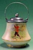 A rare McIntyre Golfing biscuit barrel decorated with a Victorian red jacketed golfer, playing