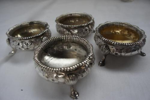 Set of four Victorian chased circular silver salts with gadrooned borders, floral decoration,