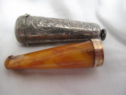 Silver case containing amber Bakelite cheroot holder with 9ct gold collar. Both Birmingham 1900.