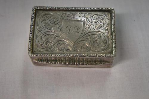 Edwardian silver snuff box of rectangular form with framed border and feather engraving to top.