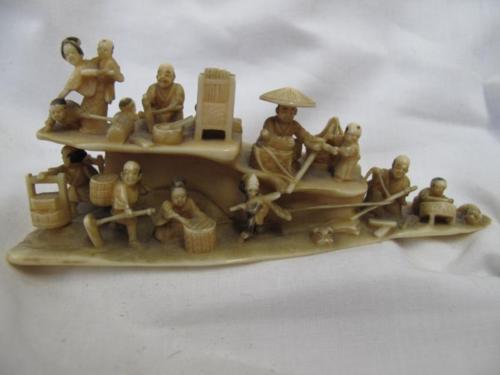 Late 19thC Japanese finely carved ivory figure group on a tiered log with numerous figures and