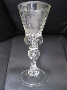 18thC German engraved cordial glass with conical-shaped bowl, baluster stem encasing air bubble on