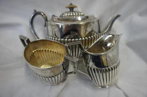 Half-fluted, oval, three-piece silver tea service. 19.5 ozt.