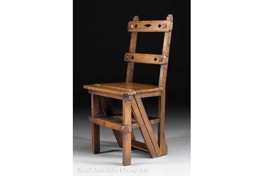 An English Modern Gothic Carved Oak Metamorphic Library Chair, late 19th c., pierced crest and slat,