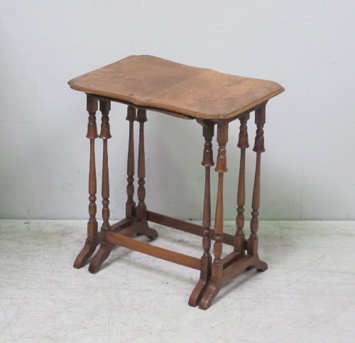 A nest of two walnut occasional tables, with serpentine shaped tops. 52cm.