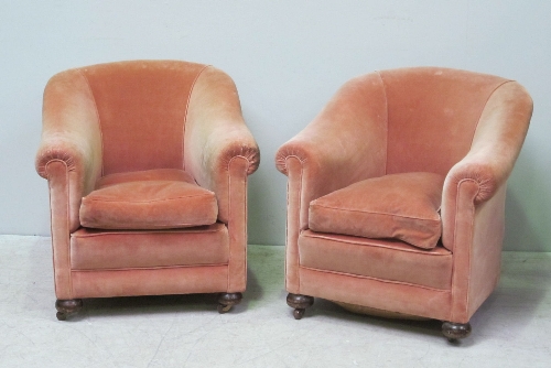 A pair of pink upholstered tub chairs, on button feet.