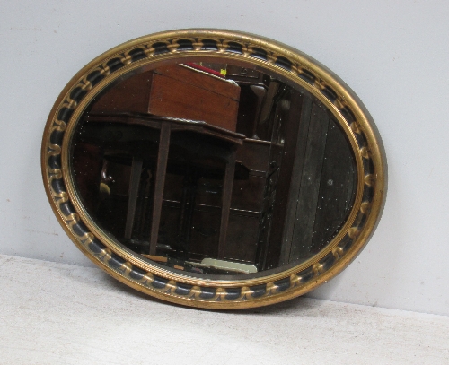 A gilt framed oval wall mirror, 87cm.