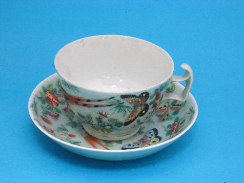 A Chinese green celadon tea cup and saucer, decorated with exotic birds and flowers.