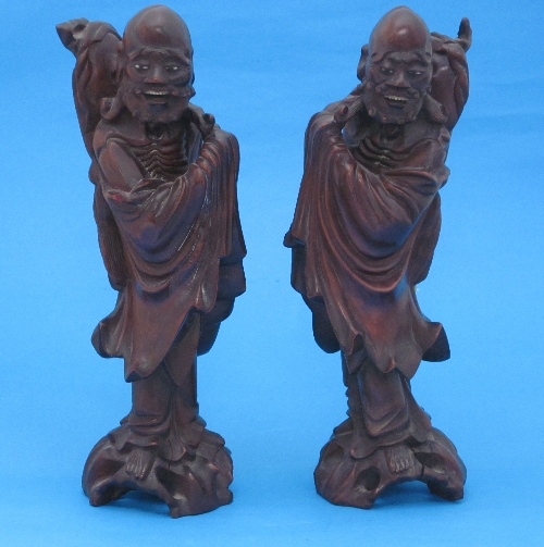 A pair of Oriental carved wood figures, of two men in robes, 29cm.
