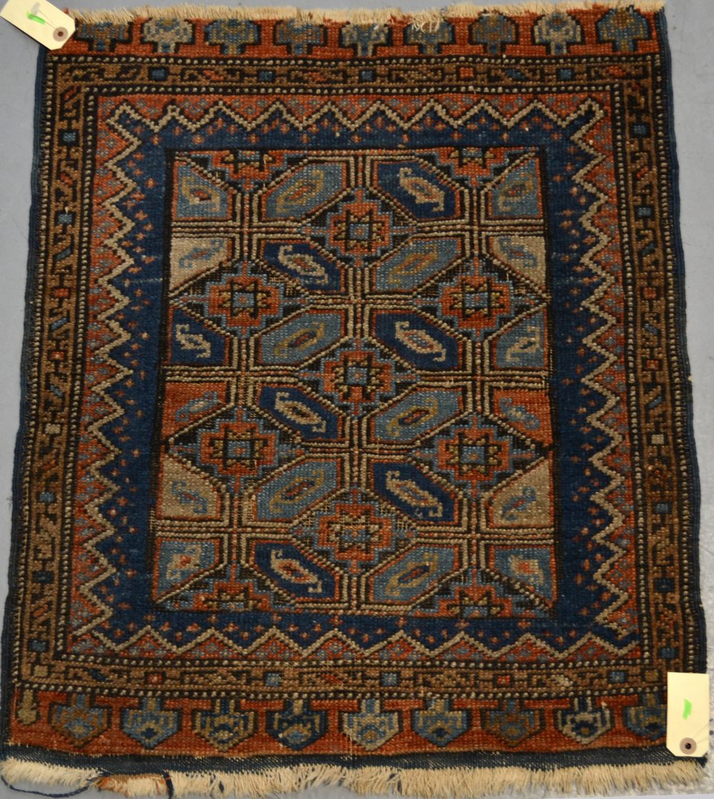 North west Persian mat, about 1930, 2ft. 3in. x 1ft. 11in. 0.69m. x 0.59m. Slight loss to top end.