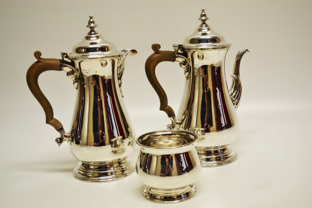 A silver cafe au lait set, the baluster bodies with either a cast fluted leaf capped swan neck spout