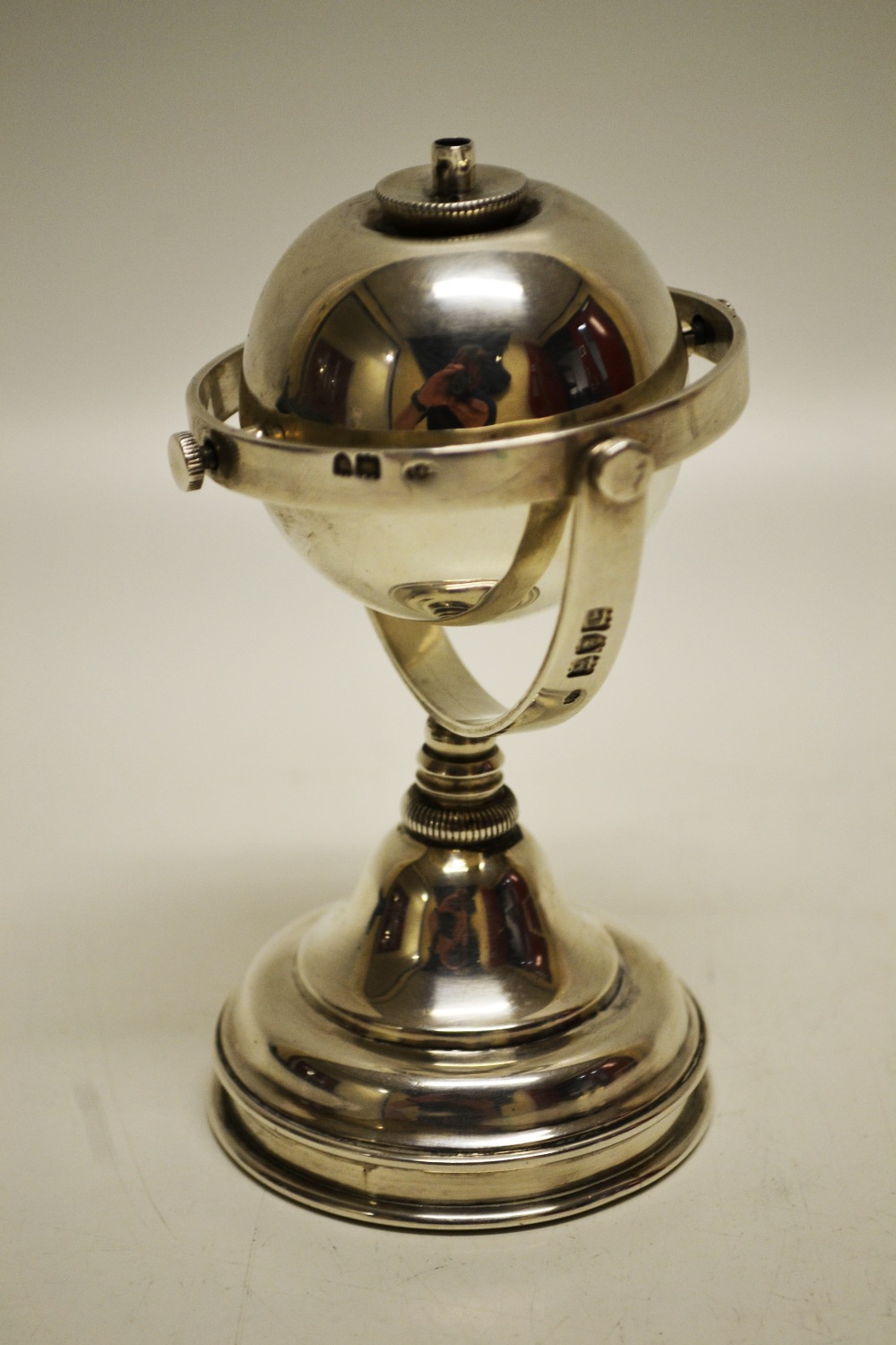 An unusual late Victorian Yachtsman`s, silver cigar lighter, the globe spirit reservoir suspended on