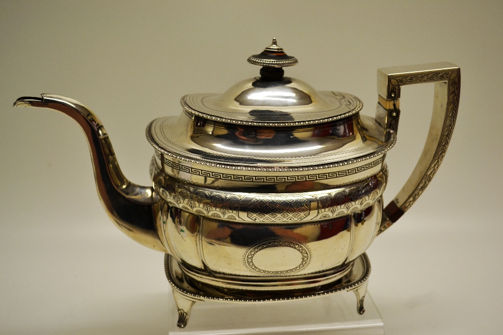 A George III silver rectangular teapot and matching stand, with oval border cartouches engraved