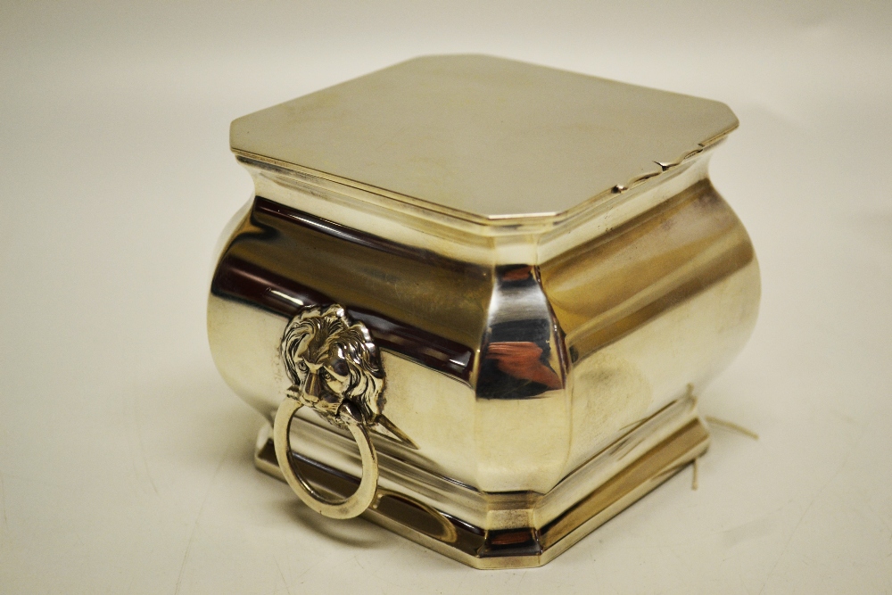 An Edwardian square silver tea caddy, the ogee sides with angled corners, lion mask ring side