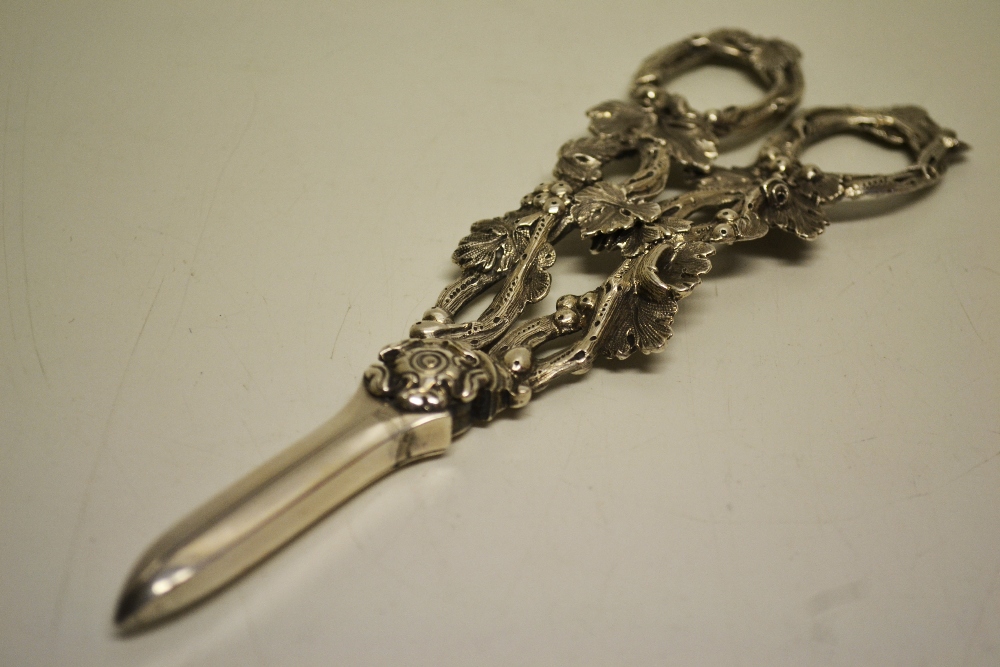 A pair of Victorian silver cast grape shears, with open vine handles. Makers Martin and Hall,