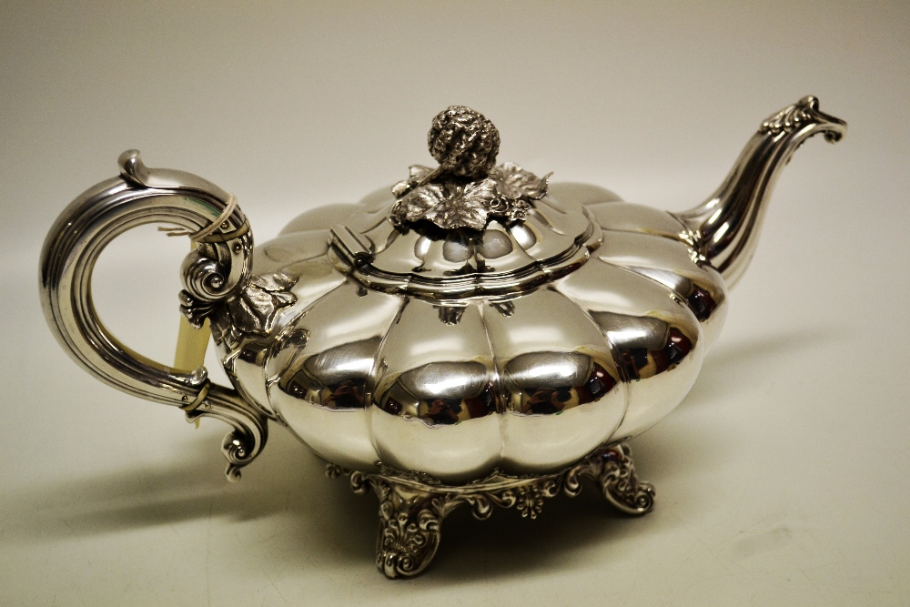 A William IV silver melon panelled compressed circular teapot, with a moulded shell capped swan neck
