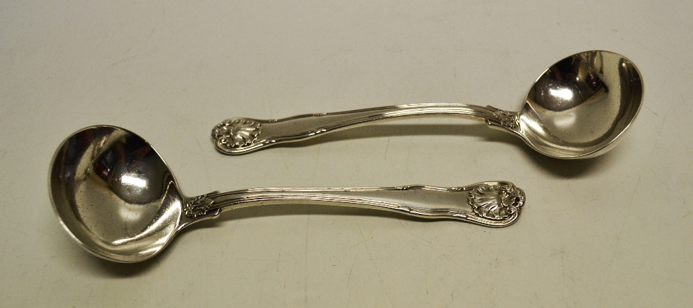 A pair of George IV Kings Husk pattern silver sauce ladles, engraved an armorial in a shaped shield.