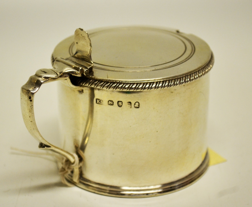 A large Regency silver drum shape mustard pot, with a gadroon rim, a blue glass liner, the hinged