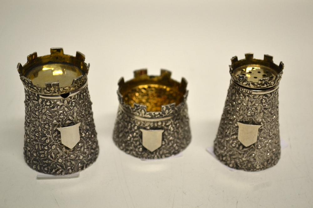 A novelty Victorian silver three piece condiment set in the form of towers with battlements, diverse