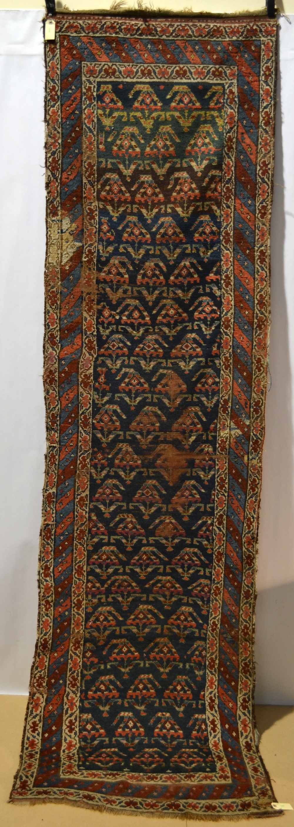 Kurdish runner, north west Persia, early 20th century, 10ft. 5in. x 2ft. 10in. 3.17m. x 0.86m.