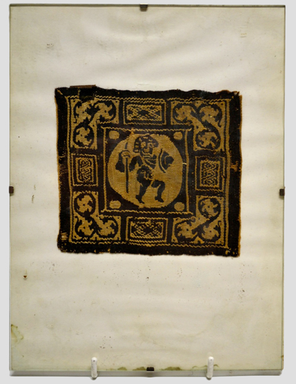 Very fine Coptic embroidered square from a tunic, depicting a marching warrior holding a spear and