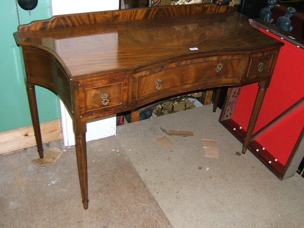 An Edwardian copy of a Georgian Desk in Mahogany with three drawers.