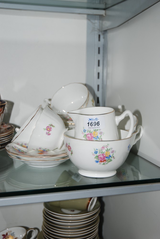 A Royal Adderley Teaset with floral design incl. six cups and saucers, five Plates, Sugar Bowl and