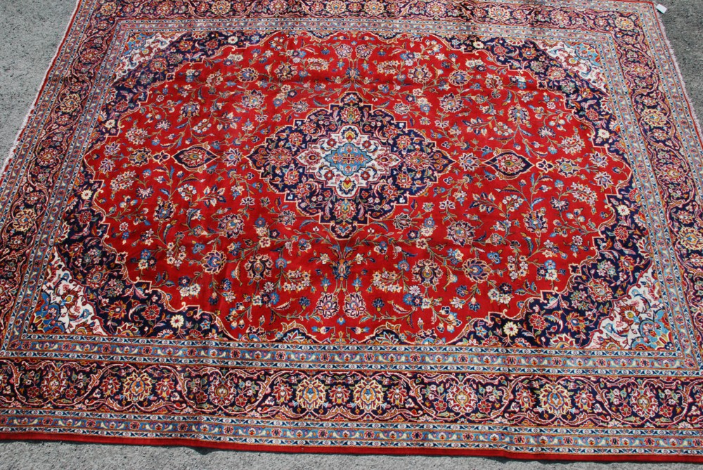 A Royal Kashan Carpet from central Persia, circa 1920, the rich tomato-red field scrolling vines