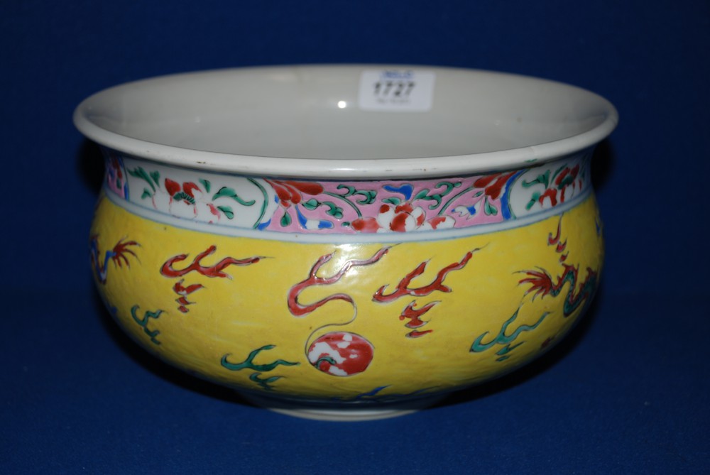 A Chinese Famille Rose Bowl decorated with dragons on a yellow background, a/f, 9 1/2'' diameter.