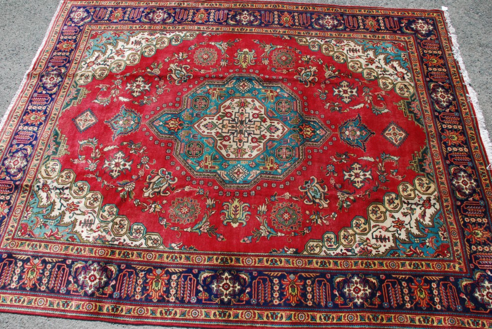 A fine Tabriz Carpet from North West Persia, circa 1950, the madder field decorated with octagonal