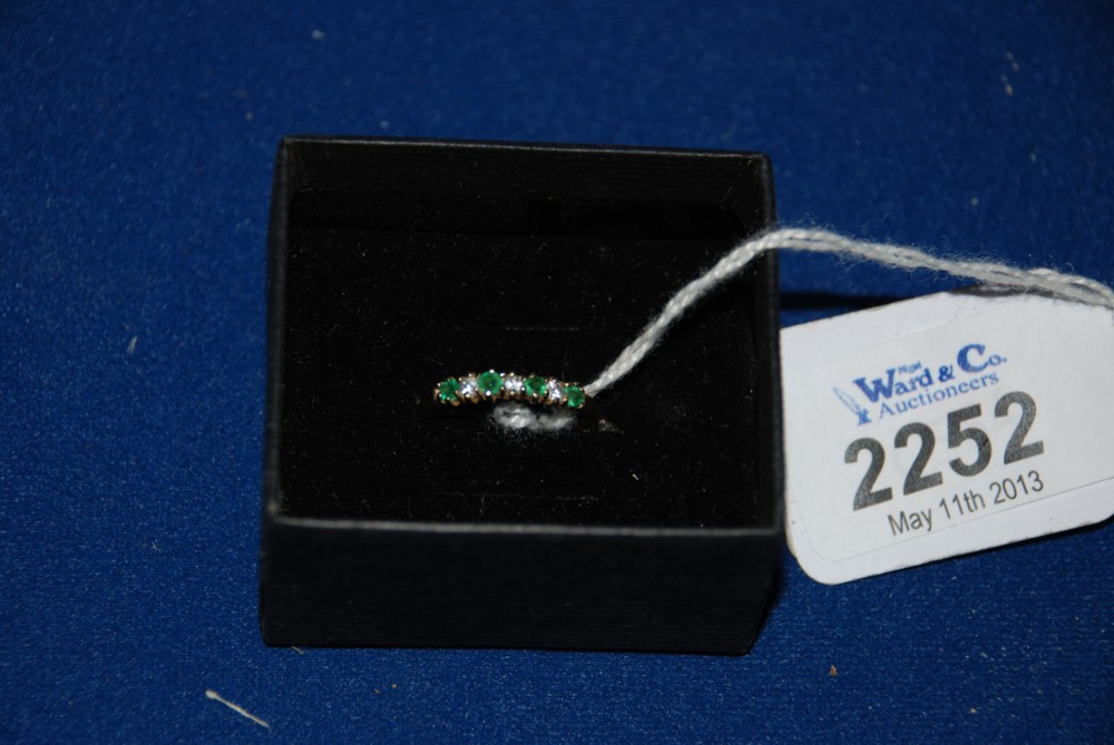A pretty 9ct Emerald & Simulated Diamond Eternity style Ring.