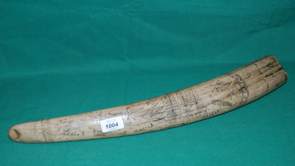 A replica scrimshaw in the shape of Tusk.