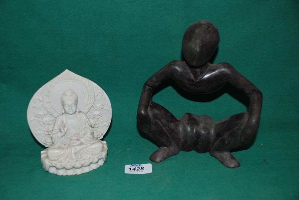 A statue of a seated Buddha and a soapstone Statue, with no torso.