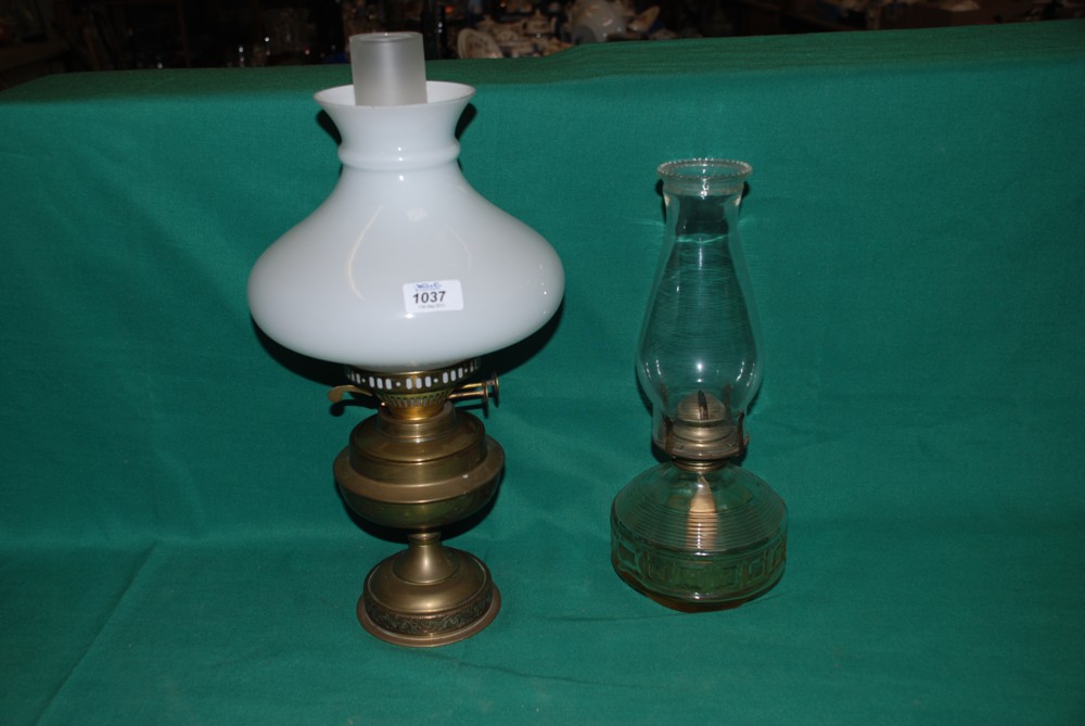 A brass Oil Lamp with chimney and shade and another Oil Lamp with glass reservoir and chimney