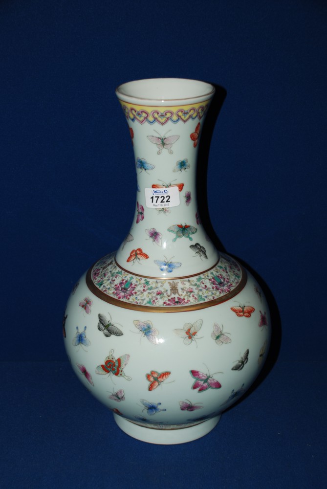 A Chinese Vase decorated in Famille Rose with a large number of butterflies, Guangxi mark to base,