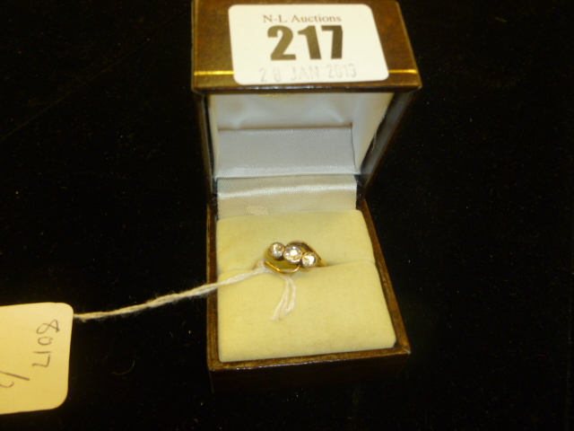 AN 18ct GOLD CROSSOVER THREE STONE DIAMOND RING