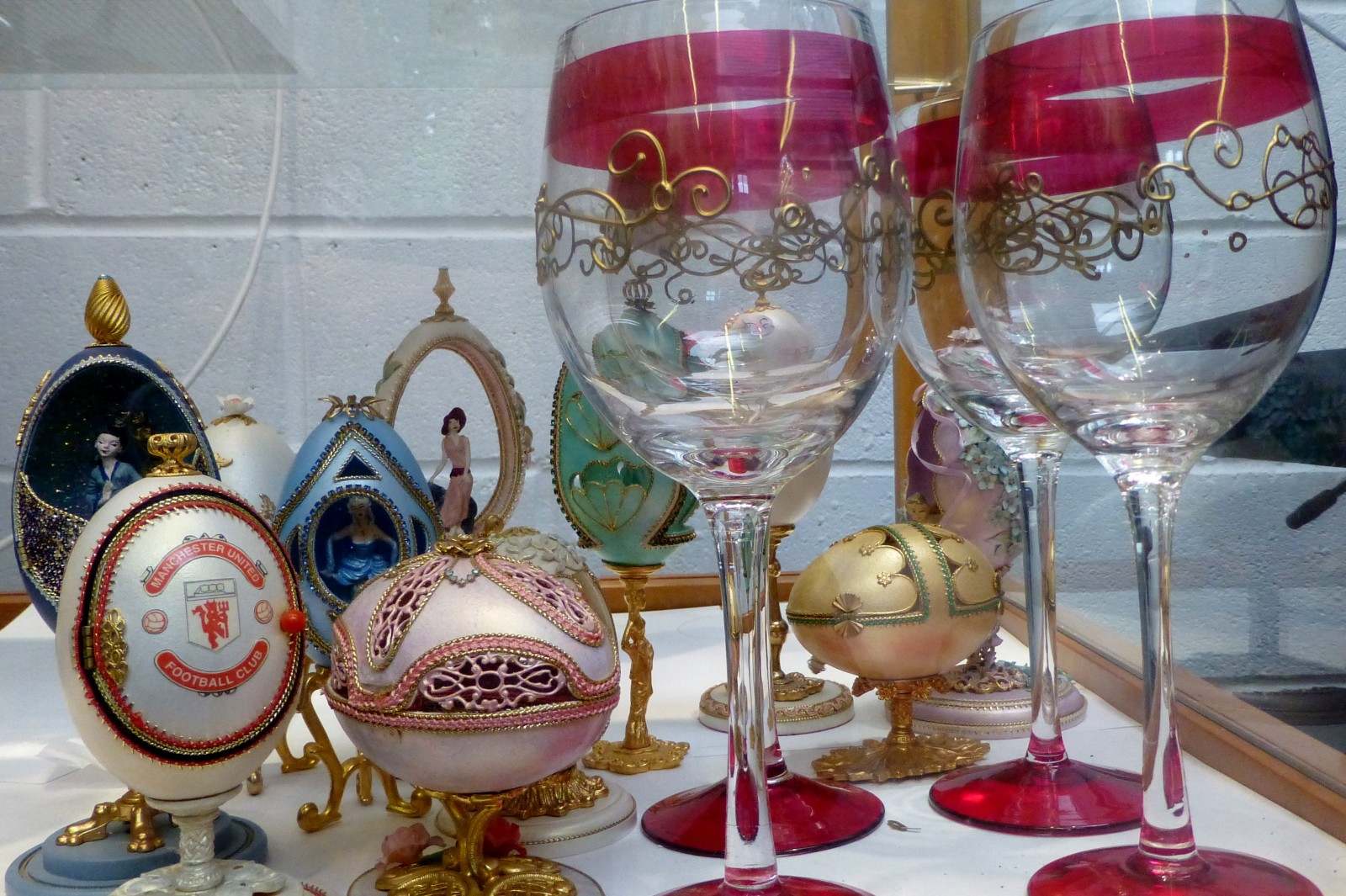 Set of six decorated wine glasses and decorative mounted eggs