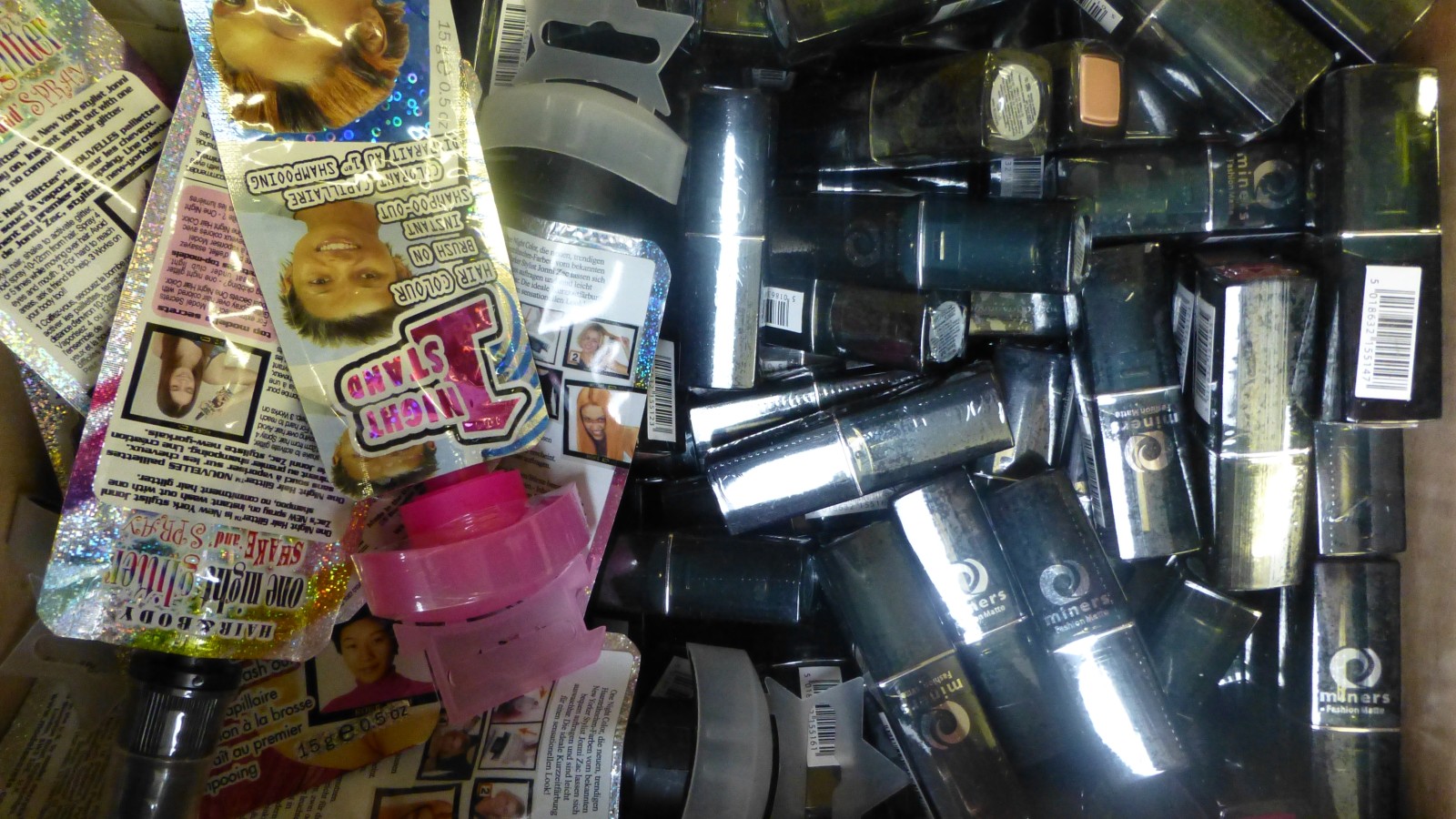 A box of new make up items and lipsticks etc