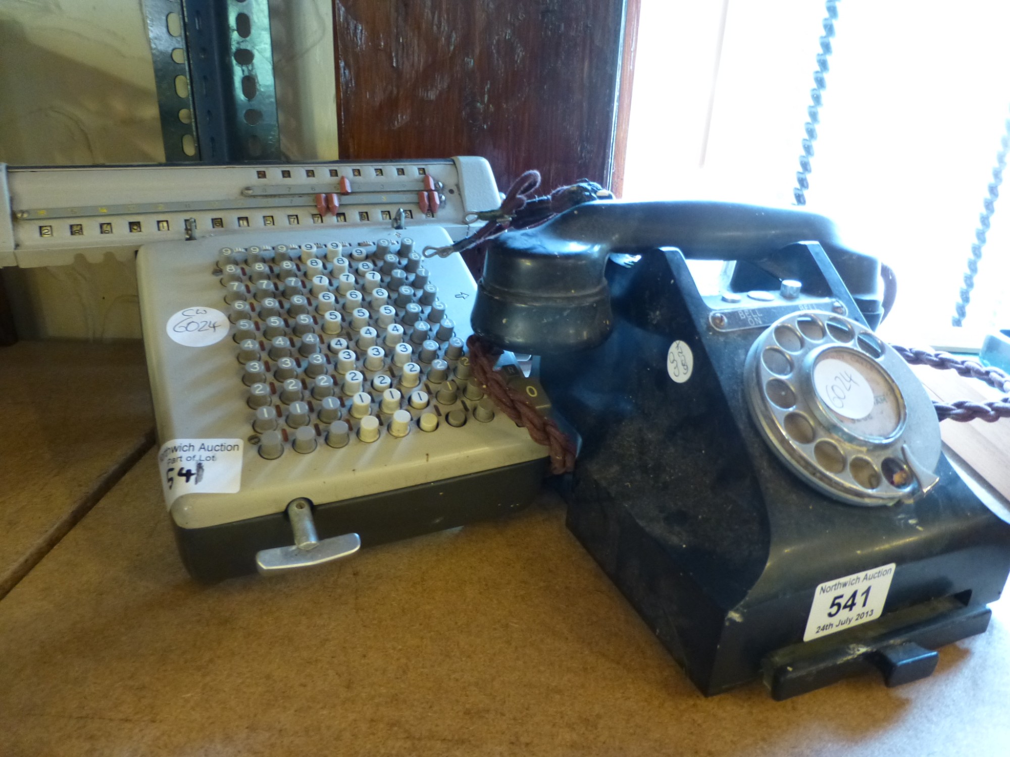 A vintage adding machine and a bakelite telephone