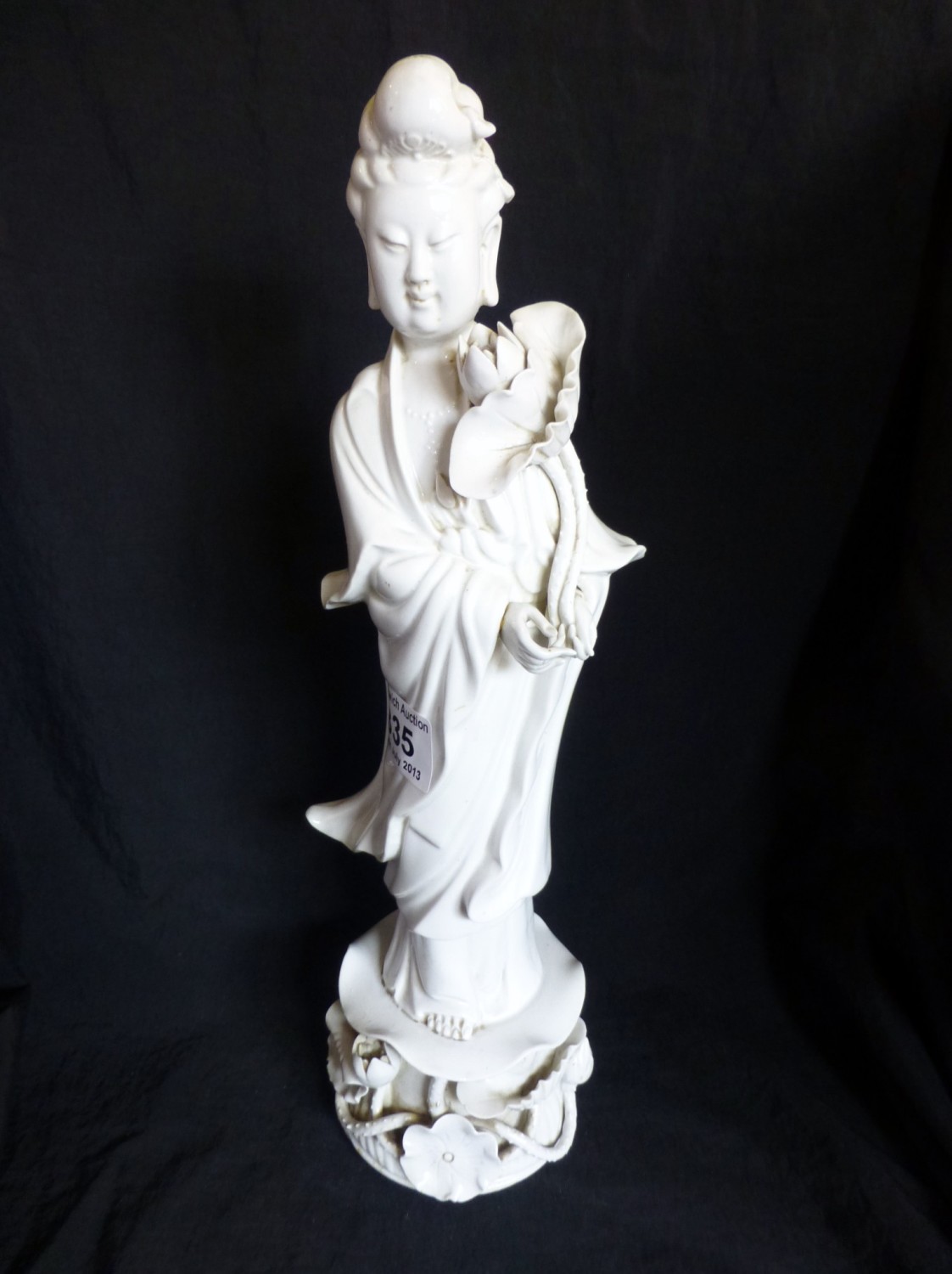 Chinese Blanc De Chine porcelain figure of Guan Yin holding lotus flower on floral base 35cm tall