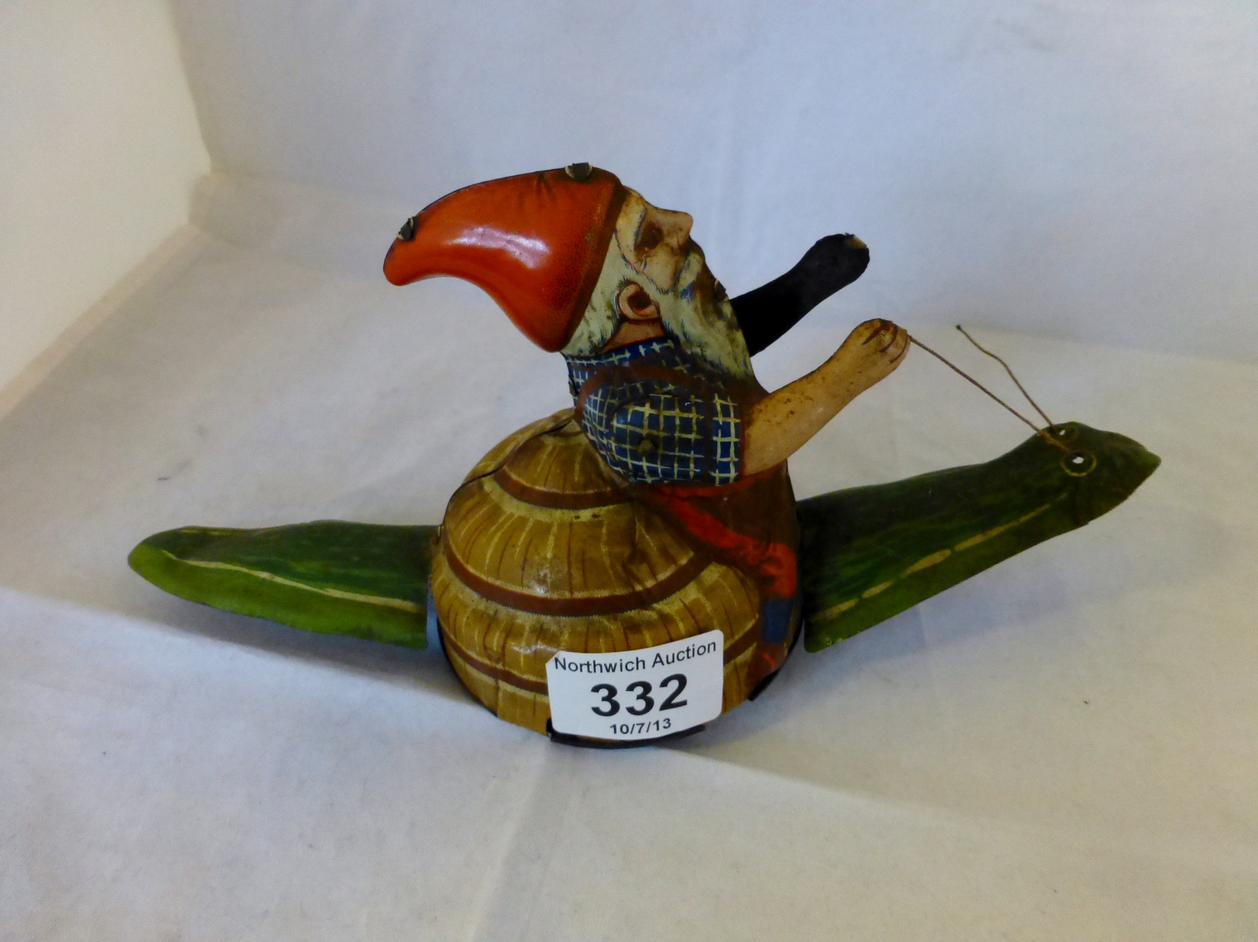 Tinplate clockwork gnome riding a snail