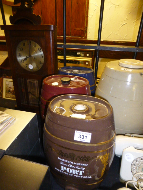 Four stoneware barrels and a wall clock